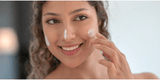 woman applying moisturizer to her face