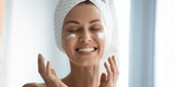 woman smiling with lotion on her face