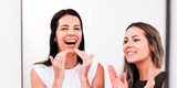 Two women laughing and applying tallow moisturizer