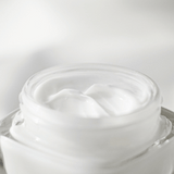 white cream in a clear glass jar