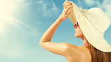 Women, sun hat, sun rays, glowing skin, at the beach