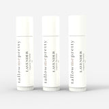 A trio of Tallow Me Pretty Lavender organic lip balm sticks lined up, showcasing their sleek and clean design, emphasizing the natural and organic care in multiples for well-hydrated and soothed lips.