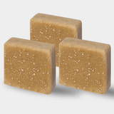 Three aligned bars of gentle tallow soap, in a soft, pale beige tone, displaying a smooth, hand-cut finish that hints at the soap's creamy and moisturizing qualities.