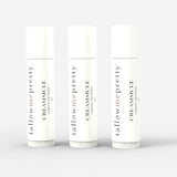 Set of three Tallow Me Pretty Creamsicle Organic Lip Balms presented against a pure white backdrop, symbolizing the trio package that offers a cohesive, hydrating lip care experience.