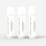 Set of three Tallow Me Pretty Peppermint Organic Lip Balms presented against a pure white backdrop, symbolizing the trio package that offers a cohesive, hydrating lip care experience.