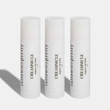 Set of three Tallow Me Pretty Creamsicle Organic Lip Balms presented against a pure white backdrop, symbolizing the trio package that offers a cohesive, hydrating tallow lip care experience.