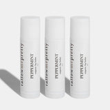 Set of three Tallow Me Pretty Peppermint Organic Lip Balms presented against a pure white backdrop, symbolizing the trio package that offers a cohesive, hydrating tallow lip care experience.