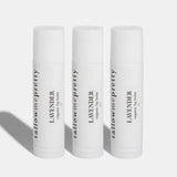 A trio of Tallow Me Pretty Lavender organic lip balm sticks lined up, showcasing their sleek and clean design, emphasizing the natural and organic care in multiples for well-hydrated and soothed lips.